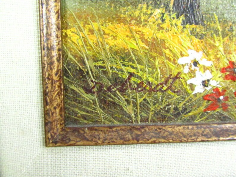 May include: A framed oil painting of a landscape with a field of tall grass and wildflowers. The painting is signed "DeWitt" in the lower right corner.