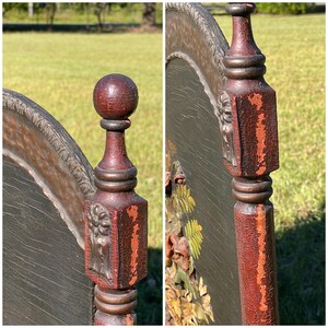 May include: Close-up of a section of an antique bed frame. The frame is made of dark wood with red accents and carved floral details. The headboard has a dark background with carved flowers and leaves.