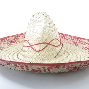 May include: A large, straw sombrero with a red trim and a red ribbon woven into the crown.