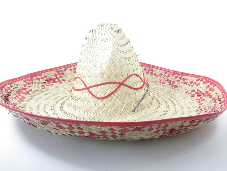 May include: A large, straw sombrero with a red trim and a red ribbon woven into the crown.