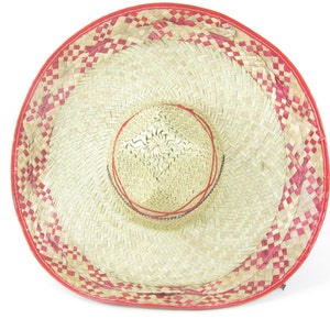 May include: A large straw sombrero with a red and white checkered pattern around the brim.