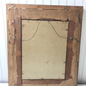 May include: A vintage wooden picture frame with a brown finish. The frame has a simple design and is in good condition.