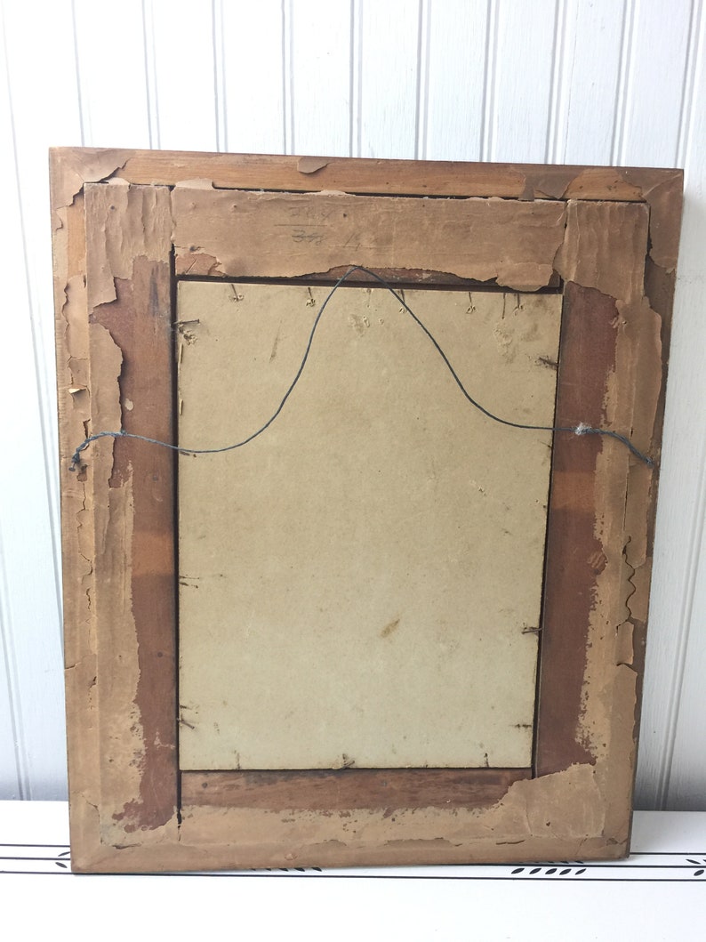 May include: A vintage wooden picture frame with a brown finish. The frame has a simple design and is in good condition.