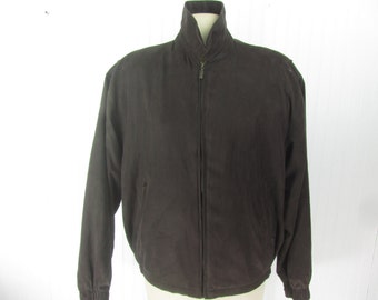 May include: A dark brown zip-up jacket with a stand-up collar and long sleeves.