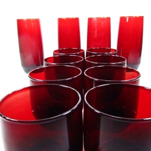 May include: Set of ten red glass tumblers. The glasses are arranged in a pyramid shape, with the tallest glasses at the back and the shortest glasses at the front.