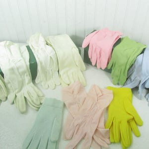 May include: Assortment of pastel colored gloves in various styles. The gloves are made of a soft, lightweight fabric and are perfect for adding a touch of elegance to any outfit.