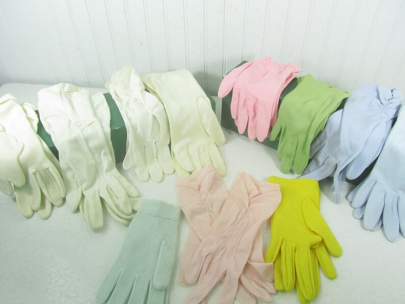 May include: Assortment of pastel colored gloves in various styles. The gloves are made of a soft, lightweight fabric and are perfect for adding a touch of elegance to any outfit.