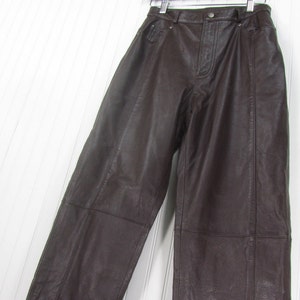 May include: Brown leather pants with a high waist and straight legs.
