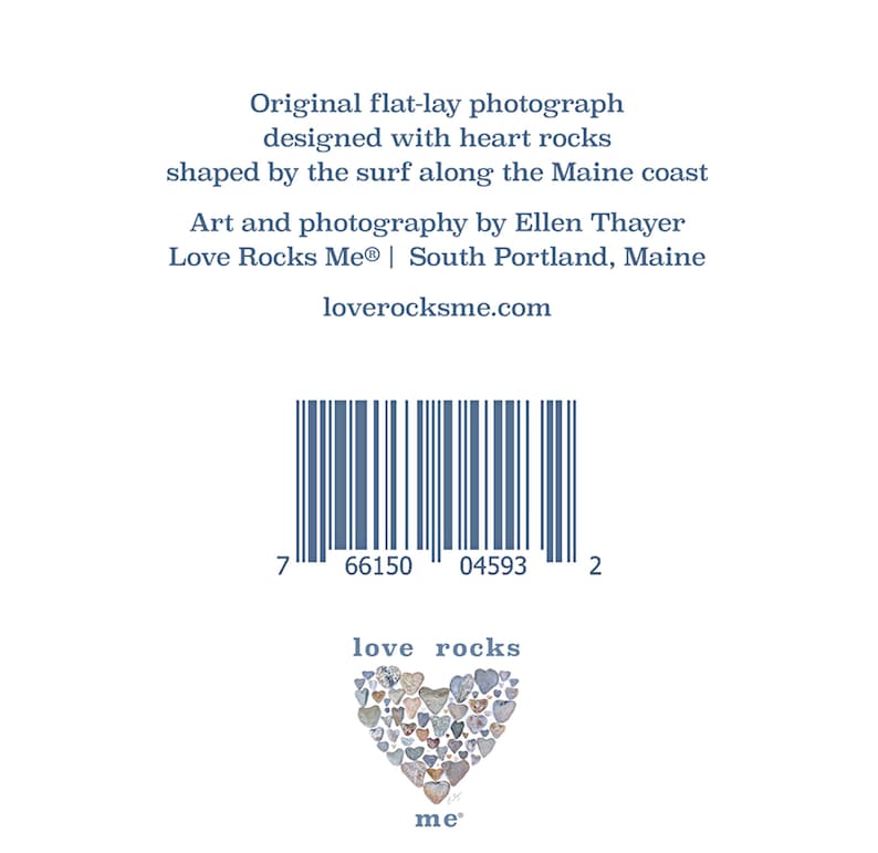 May include: A photograph of a heart made of heart-shaped rocks. The text "love rocks me" is below the heart. The image also includes a barcode with the numbers 7 66150 04593 2.