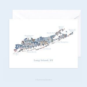 May include: A map of Long Island, New York, made of heart-shaped stones. The map includes the names of various locations on the island, including Huntington Beach, North Fork, Fire Island, Jones Beach, Orient Point, Montauk Point, and The Hamptons.
