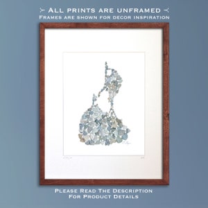 May include: A framed print of a map of Block Island, Rhode Island, created using small, gray and blue stones. The print is framed in a dark wood frame.