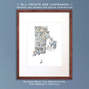 May include: A print of the state of Rhode Island, formed by small, heart-shaped stones in shades of gray, blue, and brown. The print is framed in a dark wood frame.
