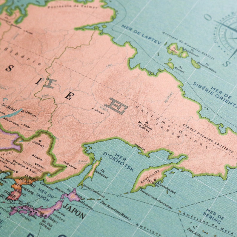 K&ouml;nnte beinhalten: Eine Vintage-Weltkarte mit hellblauem Hintergrund und gr&uuml;nen und braunen Linien. Die Karte zeigt den &ouml;stlichen Teil Russlands, einschlie&szlig;lich des Ochotskischen Meeres, der Laptewsee und der Beringsee. Die Karte ist in Franz&ouml;sisch und Englisch beschriftet.