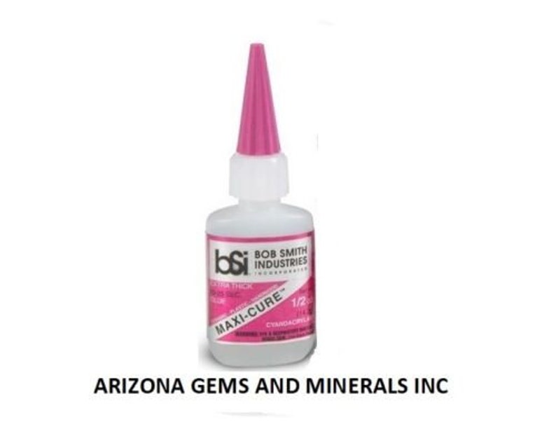 May include: A clear plastic bottle of Bob Smith Industries Maxi-Cure Extra Thick glue with a pink cap. The bottle is labeled with the brand name, product name, and size: 1/2 oz.