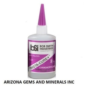 May include: A 2 ounce bottle of Insta-Cure+ gap filling glue from Bob Smith Industries. The bottle is clear with a purple cap and label with the brand name and product information.