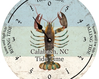 May include: A round wooden tide clock with a lobster design. The clock face is divided into two sections, one for high tide and one for low tide. The clock is labeled "Calabash, NC Tide Time".