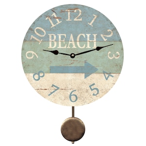 May include: A round, wooden pendulum clock with a blue and white distressed paint finish. The clock face features the word "BEACH" and a blue arrow pointing to the right. The clock has a black pendulum.
