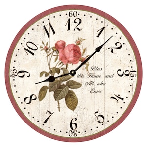 May include: A round, cream-colored clock face with black Roman numeral hour markers and black hands. The clock face features a pink rose with green leaves and the text "Bless this House and All who Enter". The clock face is surrounded by a red border.