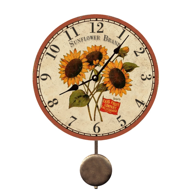 May include: A round wall clock with a vintage design. The clock face features a sunflower bouquet and the text "SUNFLOWER BRAND". The clock has black hands, a brown border, and a pendulum. The text "EARL FRUIT COMPANY CALIFORNIA" is also visible.