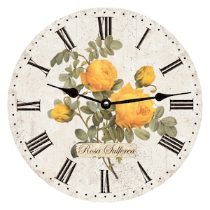 May include: A round, cream-colored clock with black Roman numeral hour markers and black hands. The clock face features a vintage-style illustration of yellow roses with green leaves and the text "Rosa Sulferea".