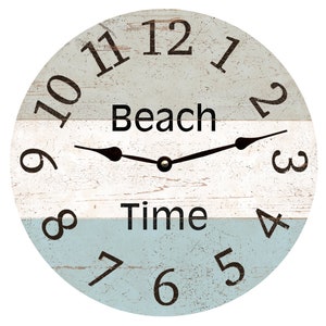 May include: A round, wooden wall clock with a distressed white and blue paint finish. The clock face features black Roman numerals and the words "Beach Time".