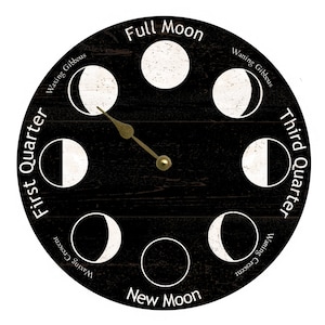 May include: A black wooden clock face with white moon phases and gold hands. The clock face is labeled with the phases of the moon, including "Full Moon", "New Moon", "First Quarter", "Third Quarter", "Waxing Gibbous", "Waning Gibbous", "Waxing Crescent", and "Waning Crescent".
