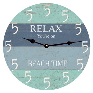 May include: A round, wooden clock with a blue and green striped design. The clock face has white numbers and the text "Relax You're on Beach Time".