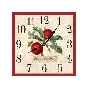 May include: A square clock with a red frame and a cream background. The clock face features black Roman numerals and black hands. The center of the clock face has a vintage illustration of red apples on a branch with green leaves. The text "Pomme De Rosée" is printed below the apples.