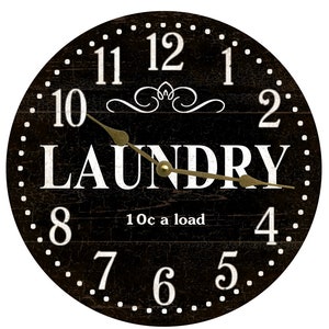 May include: Black and white laundry clock with a distressed wood look. The clock face has white numbers and a gold-colored hour and minute hand. The clock face also has the word "LAUNDRY" in white letters and the text "10c a load" in white letters.