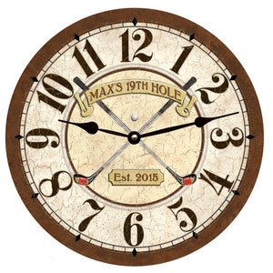 May include: A brown and cream colored clock with Roman numerals and a distressed finish. The clock face features a golf theme with crossed golf clubs and a golf ball. The text "MAX'S 19TH HOLE Est. 2015" is displayed on the clock face.
