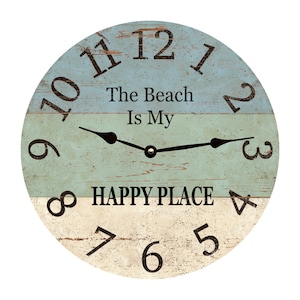 May include: A round wooden clock with a blue, green and white striped design. The clock face has black numbers and hands. The text "The Beach Is My HAPPY PLACE" is printed on the clock face.