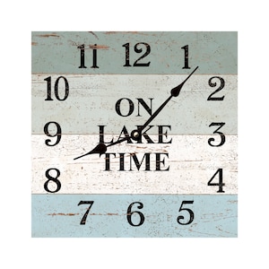 May include: A square wooden clock with a distressed blue and white paint finish. The clock face has black Roman numerals and the words "On Lake Time" in the center. The clock hands are black.