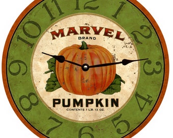 May include: A round green and orange clock with Roman numerals and a pumpkin graphic. The clock face says "MARVEL BRAND PUMPKIN CONTENTS 1 LB. 13 OZ."