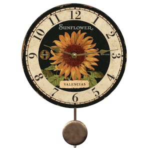 May include: A black and white pendulum clock with a sunflower design. The clock face has Roman numerals and the words "Sunflower Brand" and "Valencias".