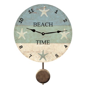May include: A round, wooden clock with a blue, white and beige striped design. The clock face features a white starfish on each of the three stripes, with the words "Beach Time" in the centre. The clock has black hands and a pendulum.