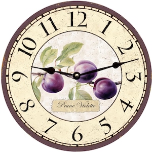 May include: A round, vintage-style clock with a cream-colored face and brown wooden frame. The clock features a purple plum design with the text "Prune Violette". The clock face has black Roman numeral hour markers and black hands.