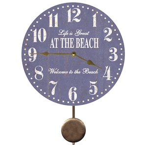 May include: A blue and white pendulum clock with the text "Life is Great AT THE BEACH" and "Welcome to the Beach".