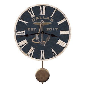 May include: A blue and white pendulum clock with a nautical theme. The clock face features Roman numerals, an anchor, and the text "Dallas Est. 2017".