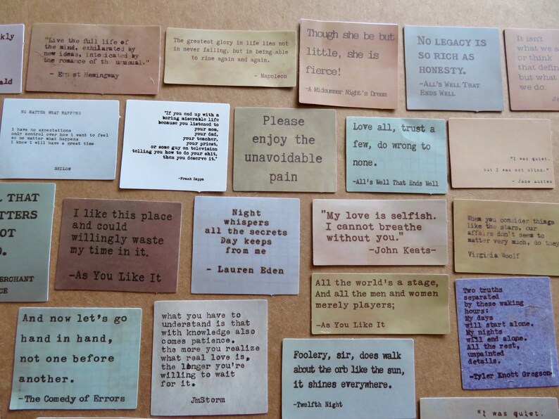 May include: A collection of small, rectangular cards with quotes in a typewriter font. The cards are in various colors, including tan, brown, and gray. The quotes are from famous authors and plays.