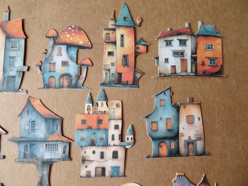 May include: A collection of whimsical, watercolor-style house cutouts in various shapes and sizes. The houses feature vibrant colors like orange, blue, and white, with unique architectural details such as turrets and mushroom-shaped roofs.