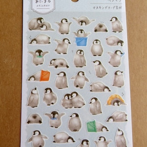 May include: A sheet of stickers featuring watercolor illustrations of penguins in various poses. The penguins are primarily gray and white, with some holding buckets or wearing accessories. The stickers are on a light blue background.