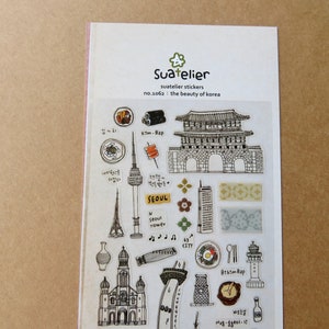 May include: A sheet of Suatelier stickers featuring illustrations of Korean landmarks and food. The stickers include drawings of a tower, a gate, food items, and the text "SEOUL". The sheet is labeled "no.1062: the beauty of korea".
