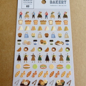 May include: A sheet of stickers with a bakery theme. The stickers feature illustrations of baked goods like bread, croissants, donuts, and muffins, along with coffee cups and bakery staff. The sheet has the word "BAKERY" at the top.