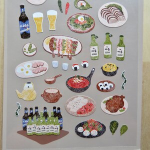 May include: A sheet of stickers featuring various Korean food illustrations. Includes images of beer bottles, glasses of beer, grilled skewers, eggs, sushi, and other dishes. The stickers have a textured, hand-drawn appearance.
