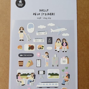 May include: A sheet of travel-themed stickers featuring illustrations of aeroplanes, boarding passes, luggage, and people. The text "DAILY DECO STICKERS" and "1158 : vlog_trip" are visible. Other stickers include a coffee cup, sandwich, and a "DUTY FREE" shopping bag.