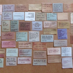 May include: A collection of vintage-style quote cards in various colors, including beige, pink, and green. Each card features a quote in a classic serif font. The cards are arranged on a neutral surface, creating a visually appealing display.
