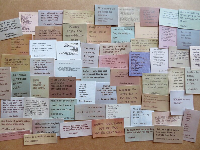 May include: A collection of small, rectangular cards with quotes in various fonts and colors. The cards feature quotes from famous authors and historical figures, perfect for journaling or scrapbooking.