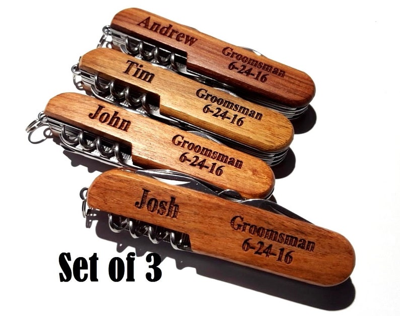 May include: Set of three wooden pocket knives with personalized names and the text "Groomsman 6-24-16" engraved on each.