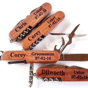 May include: Four wooden handled multi-tools with personalized engravings. Each tool has a corkscrew, bottle opener, and other tools. The engravings include names, titles, and the date 07-02-16.