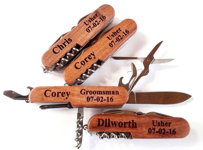 May include: Four wooden handled multi-tools with personalized engravings. Each tool has a corkscrew, bottle opener, and other tools. The engravings include names, titles, and the date 07-02-16.
